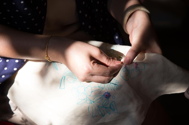 hands holding embroidered cloth